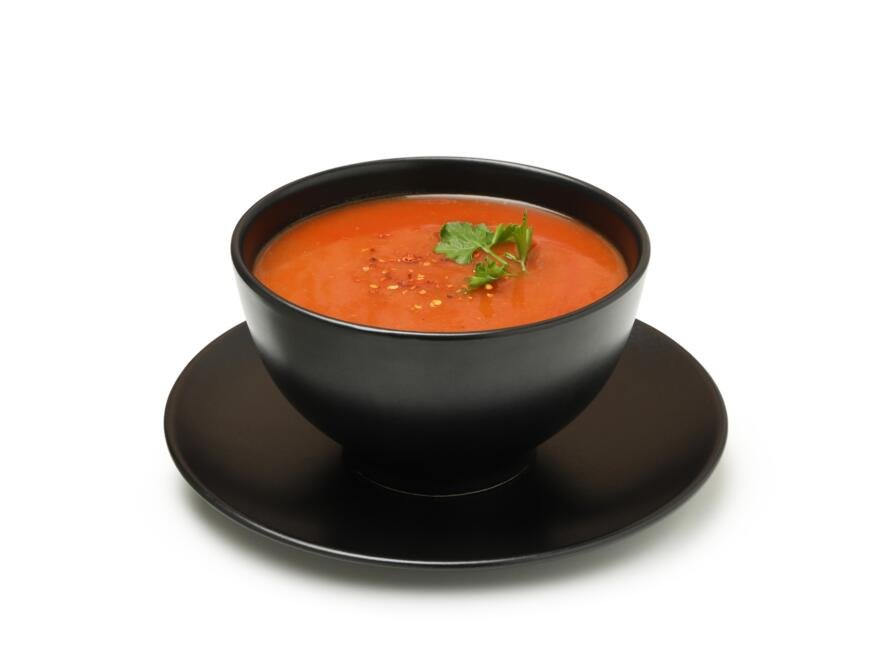 Bowl of tomato soup isolated on white background